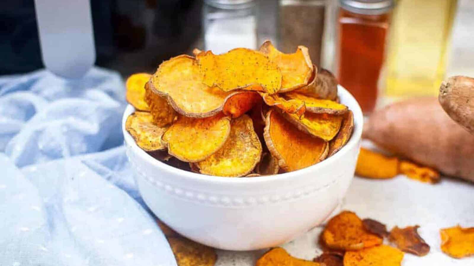 White bowl filled with sweet potato chips.