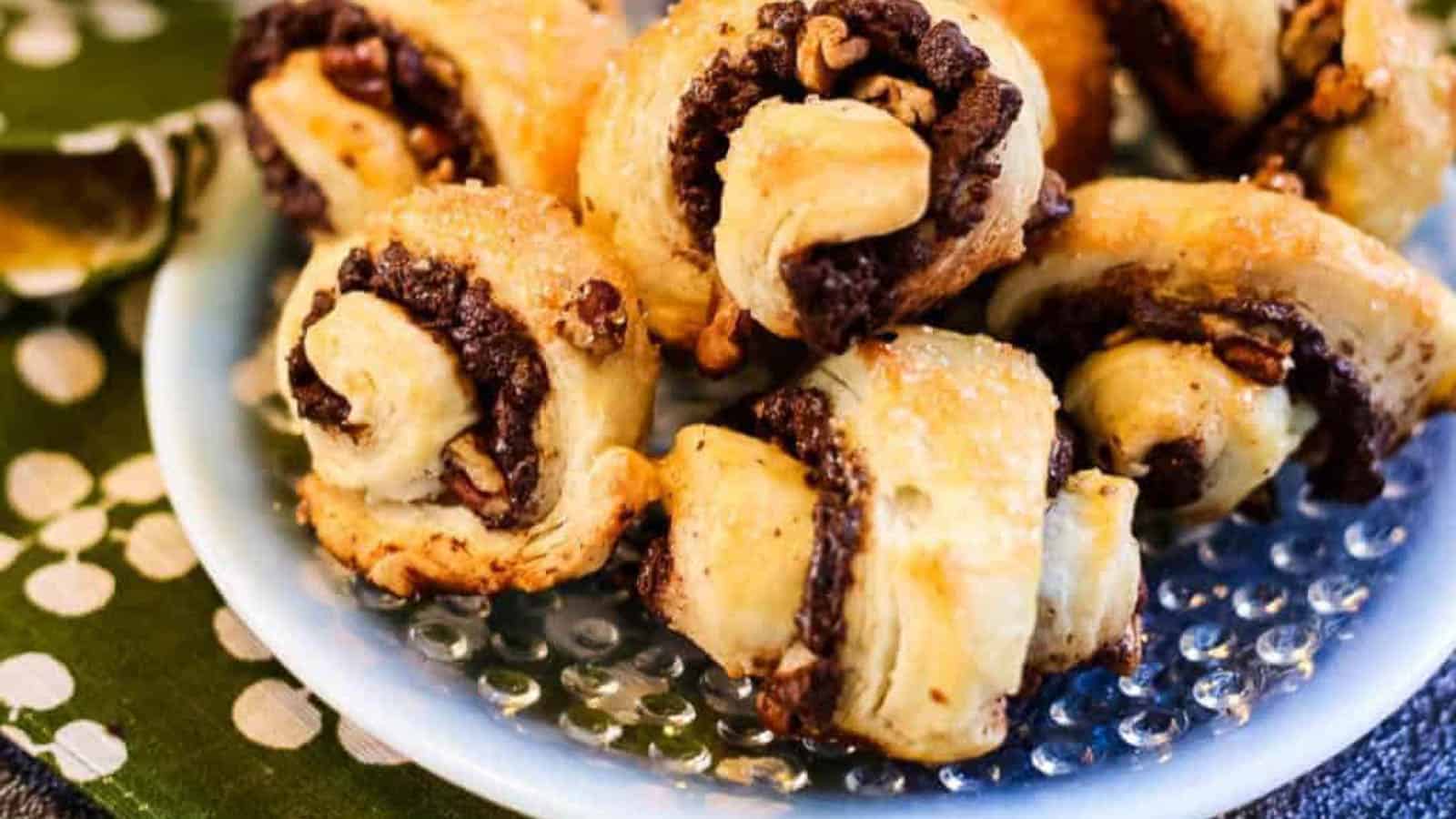 Low angle shot of rugelach cookies filled with chocolate and pecans.