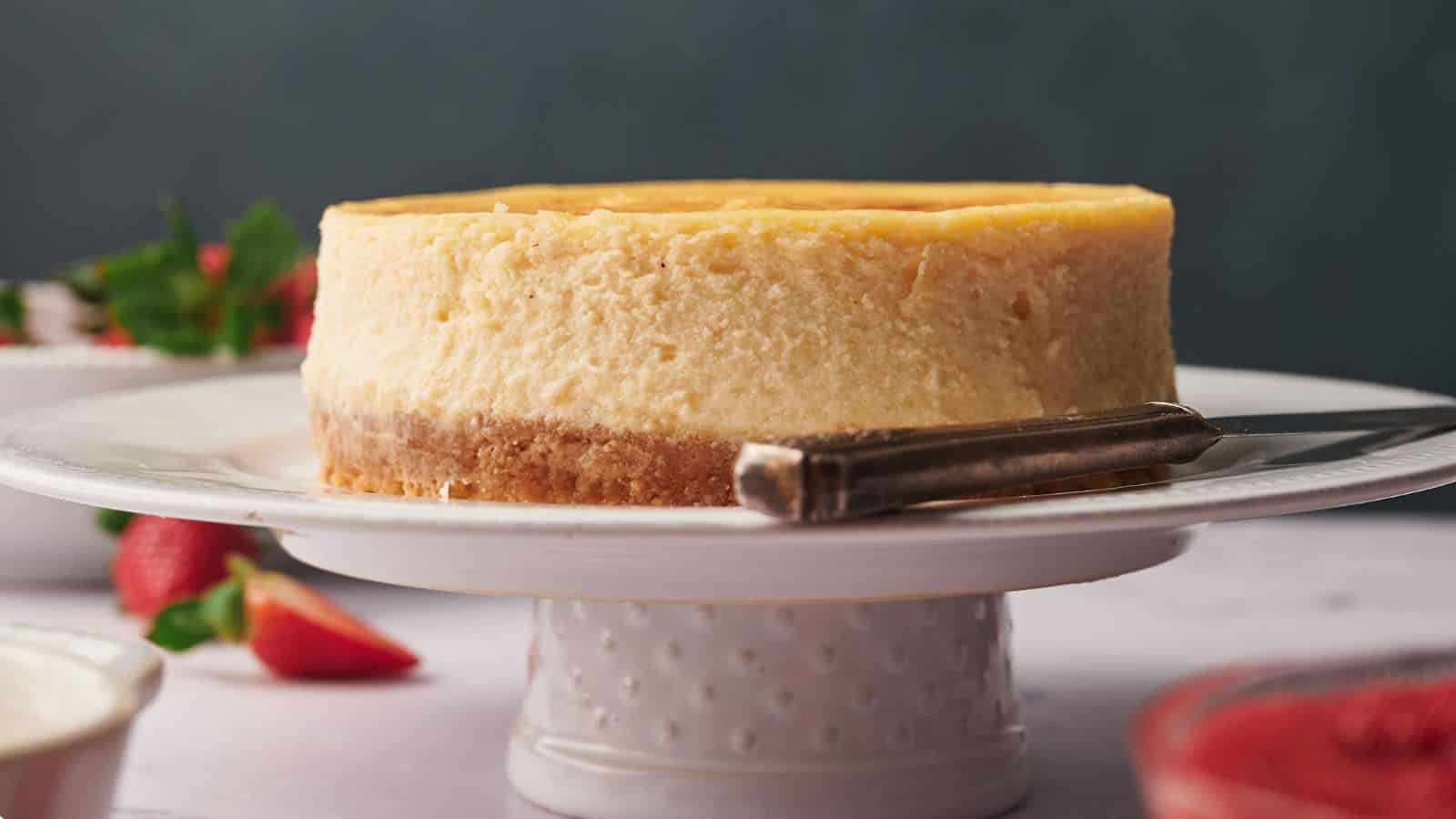 A cheesecake on a cake stand.