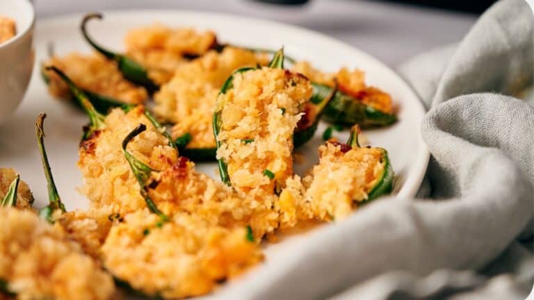 Freshly made jalapeño poppers on a plate.