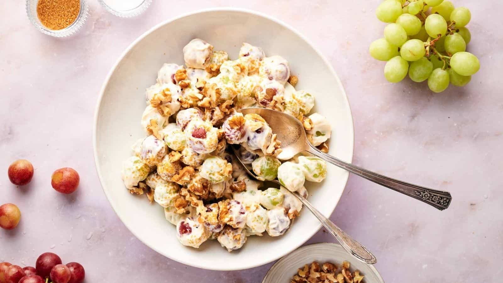 Homemade fresh grape salad in a serving bowl with walnuts scattered on top.