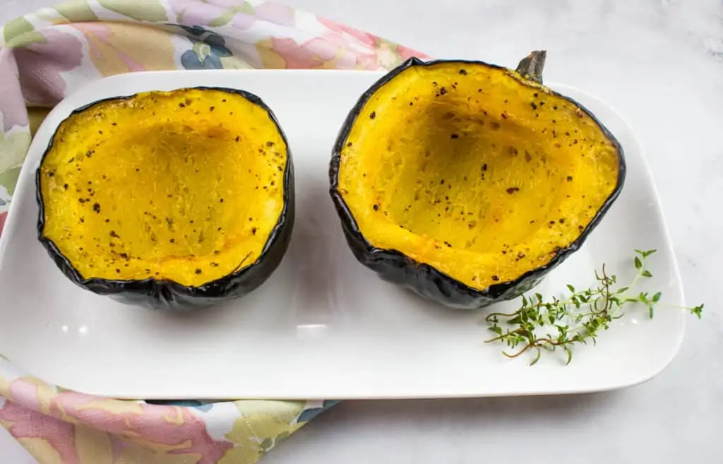 Acorn squash after air frying with some of the insides scooped up on a fork.