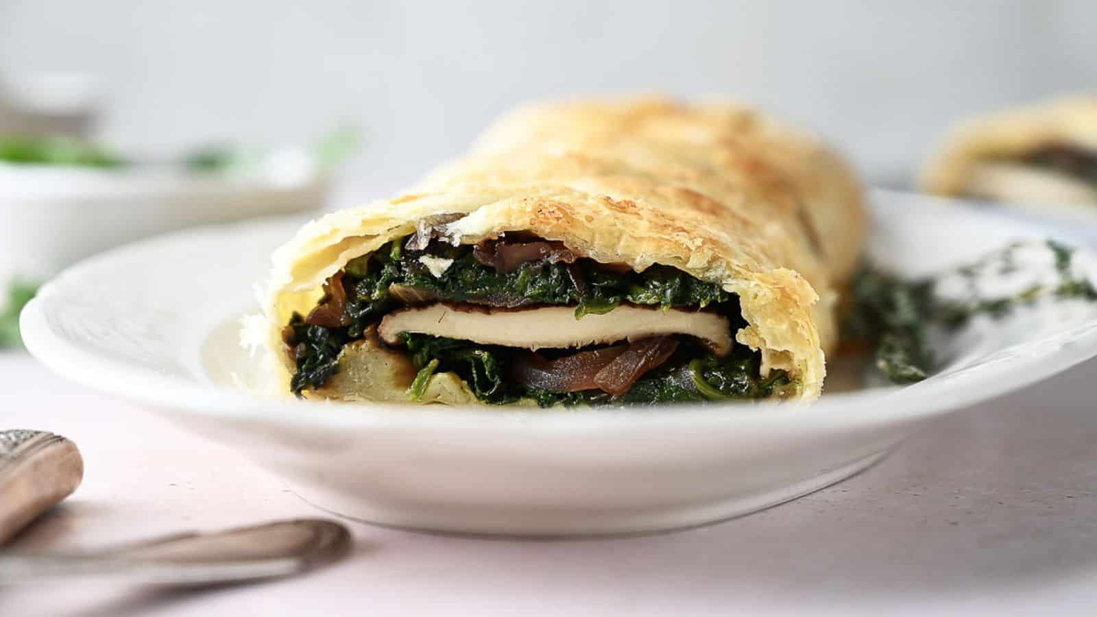 Mushroom wellington on a white serving plate.