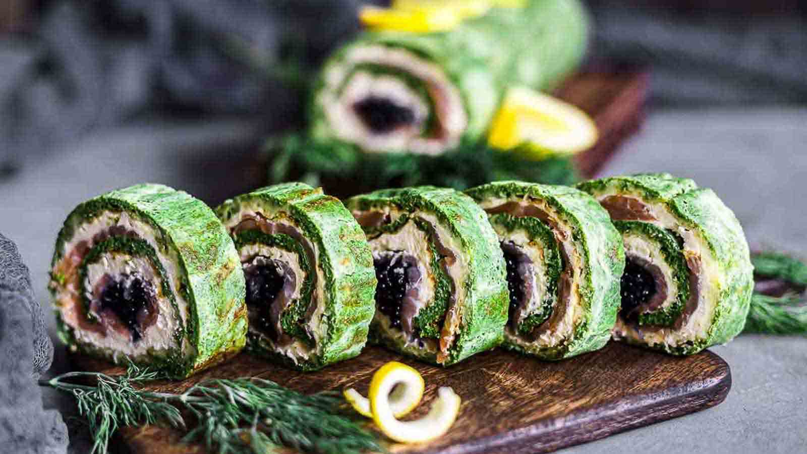 Spinach Salmon Rolls on a wooden board. 