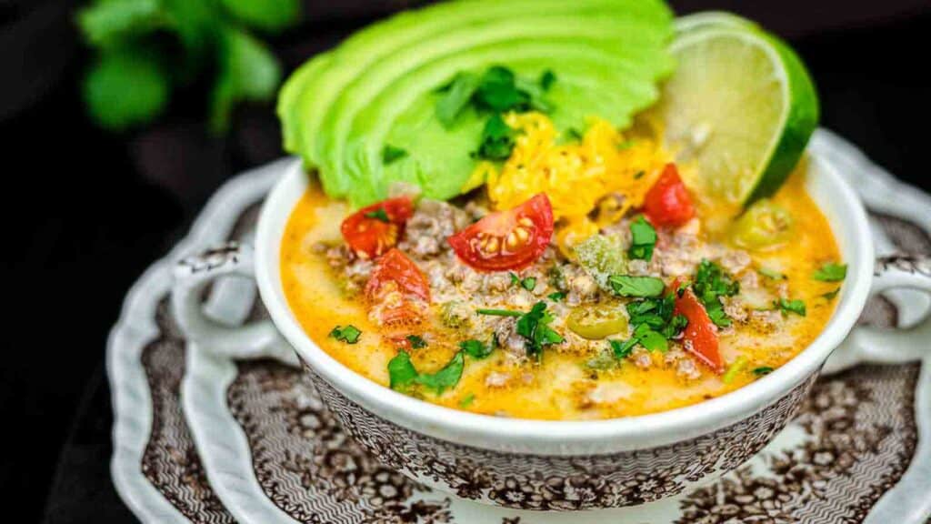 Creamy Taco Soup with fresh avocado slices and lime.