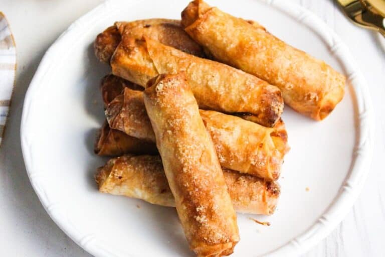 Fried spring rolls on a white plate.