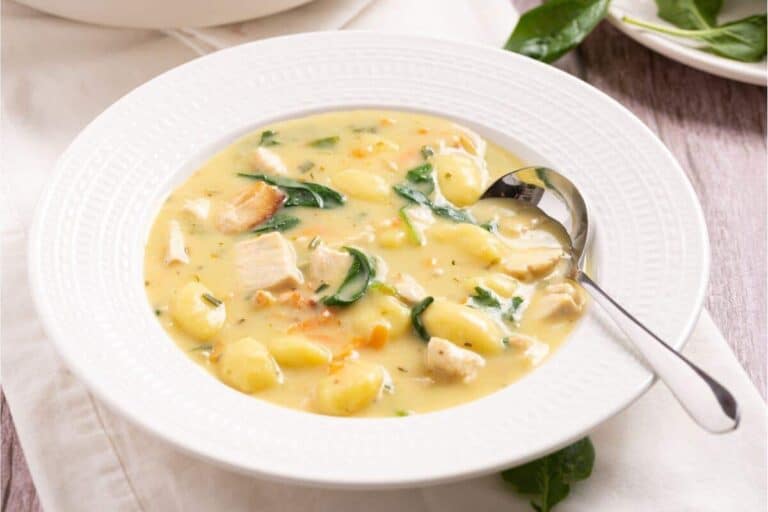 A lovely lunch idea worth taking a break for: a comforting bowl of chicken and spinach soup, served with a spoon.