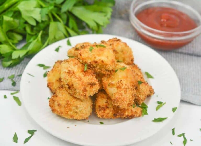 Fried chicken nuggets on a white plate.