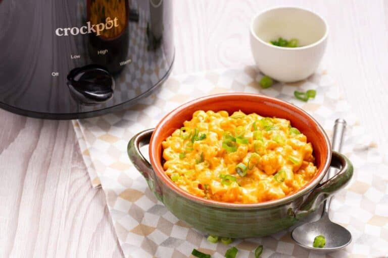 A bowl of rice in front of a slow cooker, tempting lunch idea.