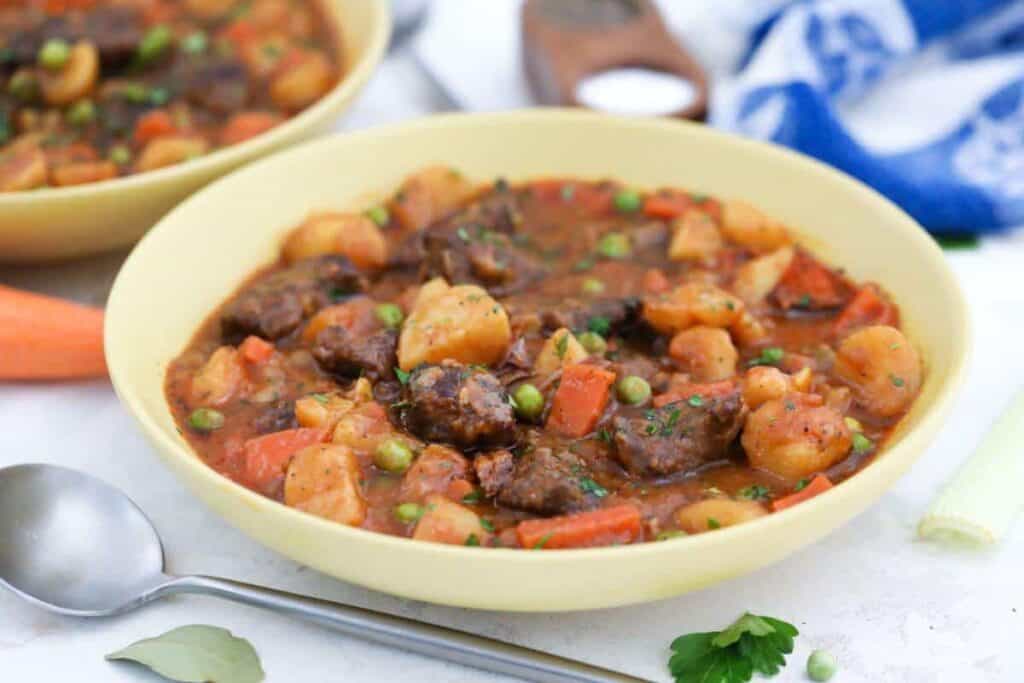 A hearty lunch idea worth taking a break for - beef stew with carrots, potatoes, and peas.