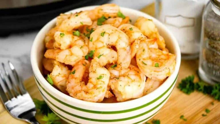 Shrimp in a bowl next to an instant pot.