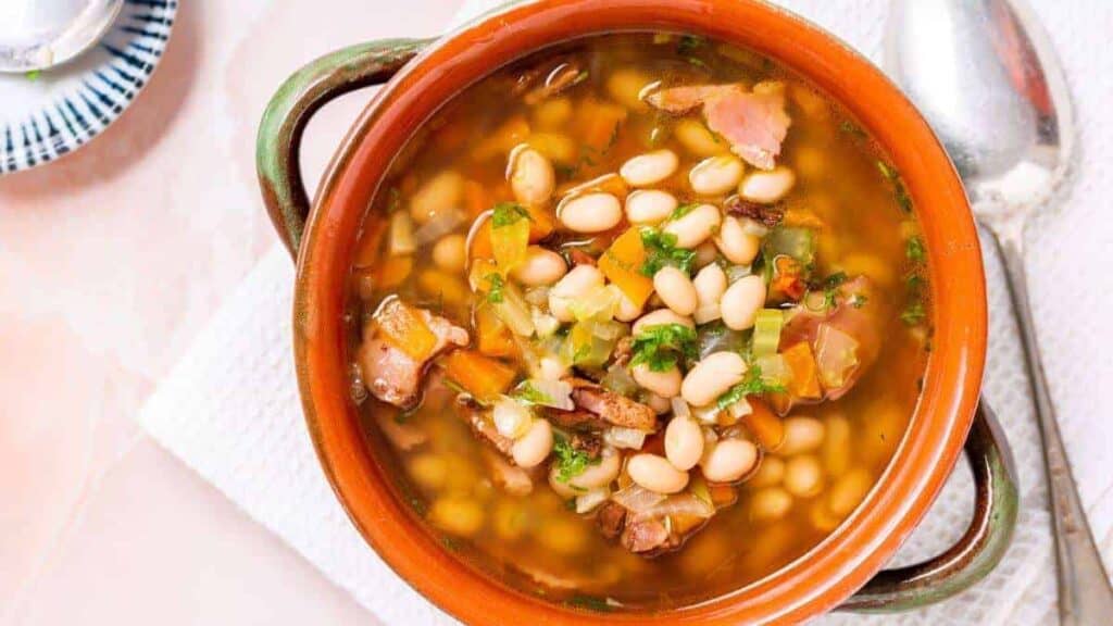 An enticing bowl of white bean soup, perfect for a delightful lunch break worth savoring.