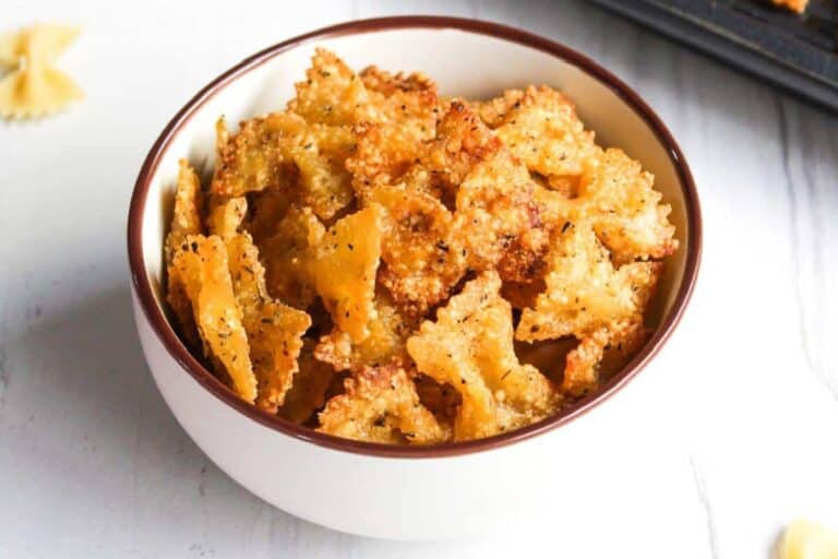 Cheesy pasta crackers in a bowl on a table.