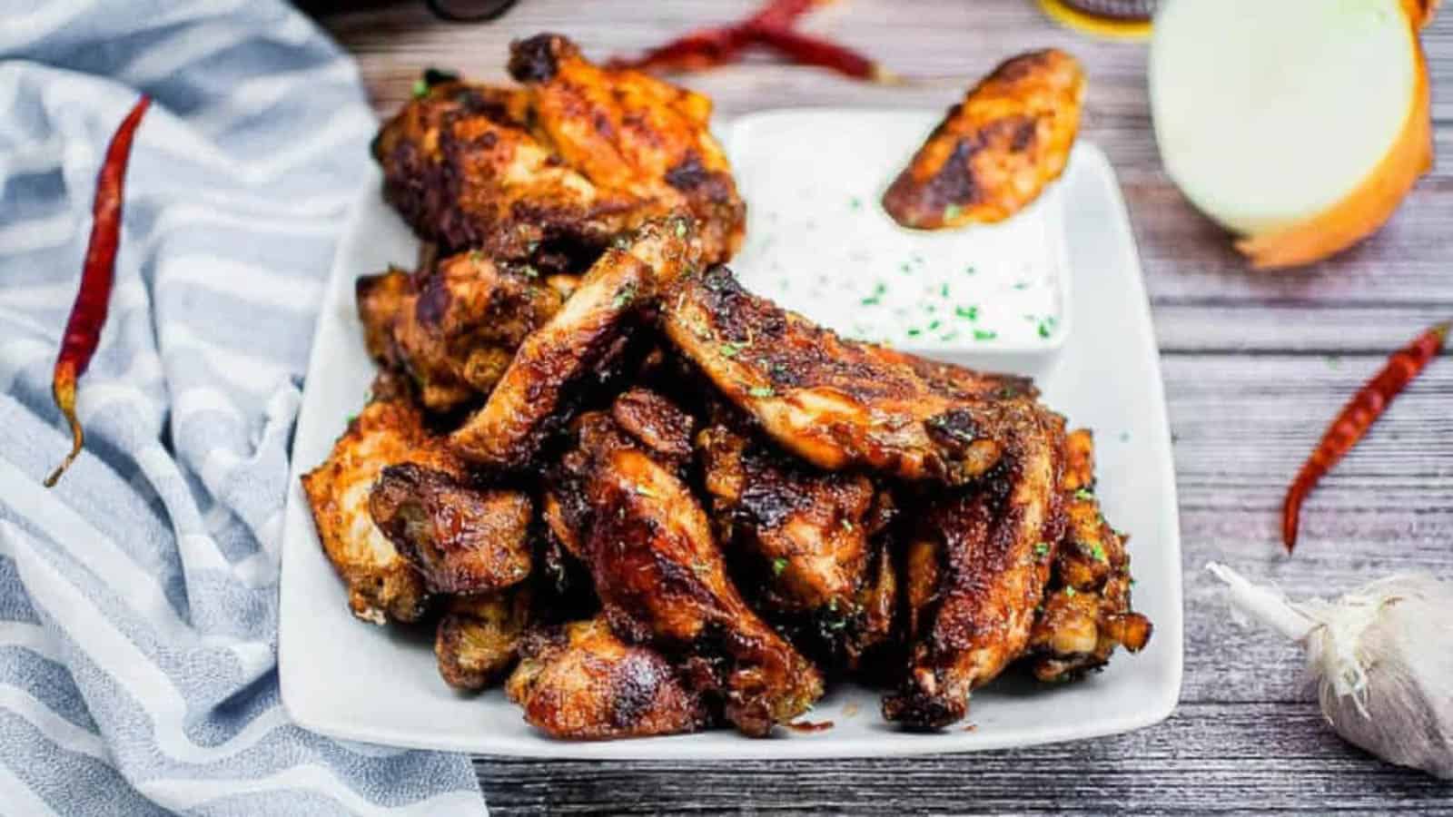 A pile of air fryer BBQ wings on a white platter.