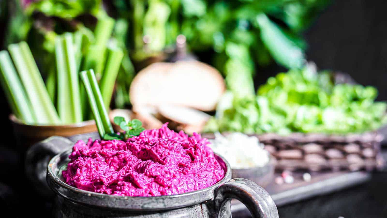 Bright purple beet spread inside a ceramic bowl.