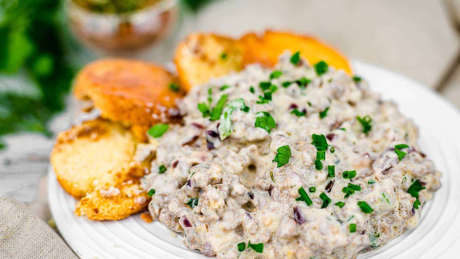 Keto gravy on a plate with biscuits. 