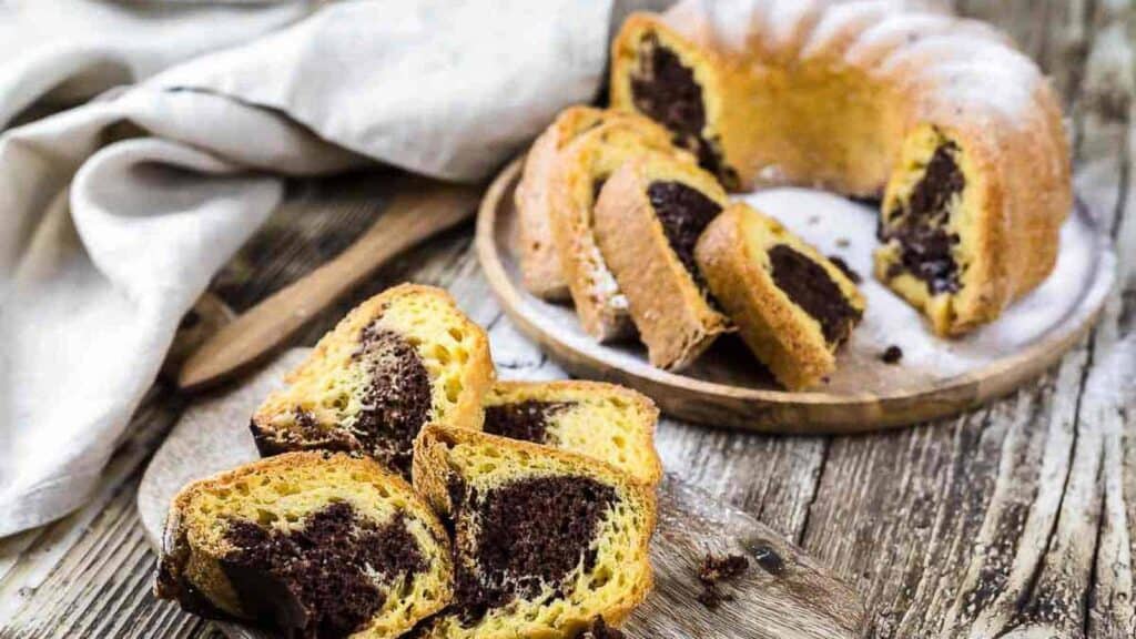 Marble Chocolate Bundt Cake cut into slices on a wooden table.