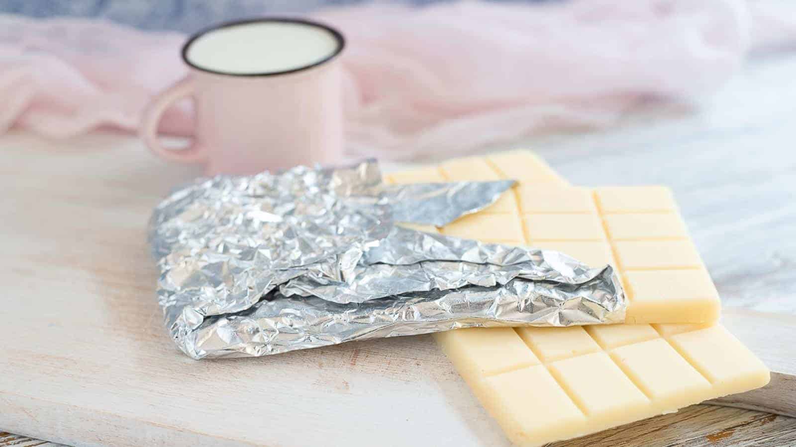 Sugar-Free White Chocolate Bar with pink jusg and napkin at the back.