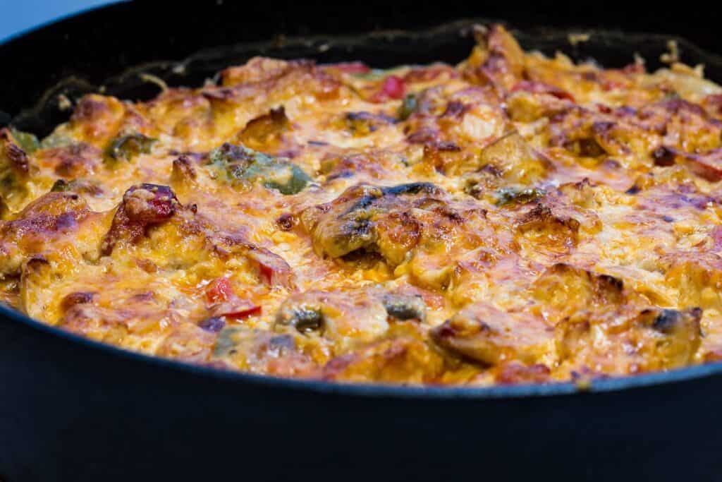 A skillet full of chicken and vegetables in a pan.