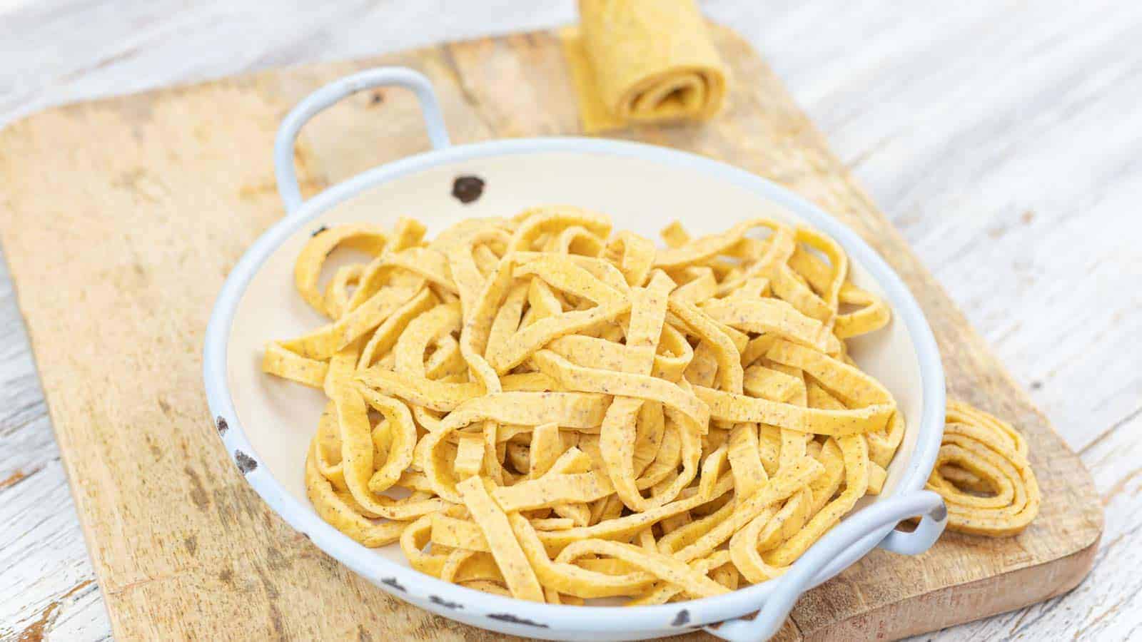 Low Carb Pasta inside light bluew bowl placed on a wooden board.