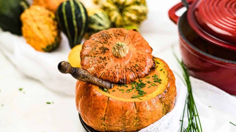 Creamy Roasted Pumpkin Soup inside baked pumpkin bowl.