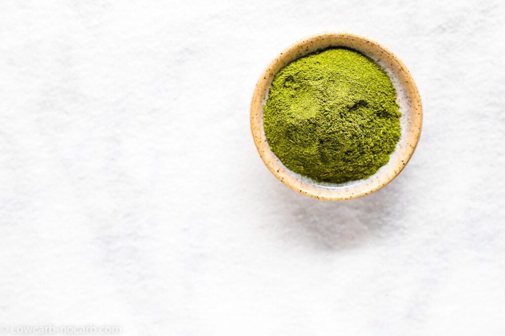 Stevia powder in a bowl on top of white table.