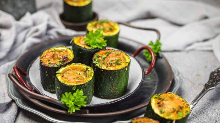 Stuffed Zucchini Mini Bites on a plate with herbs.