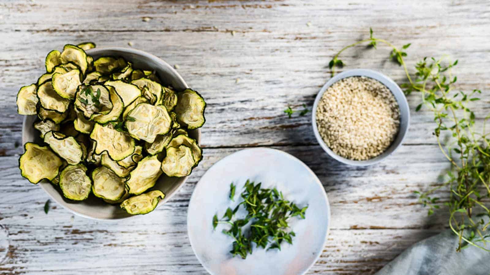  Zucchini Chips Dehydrated on a wooden table.