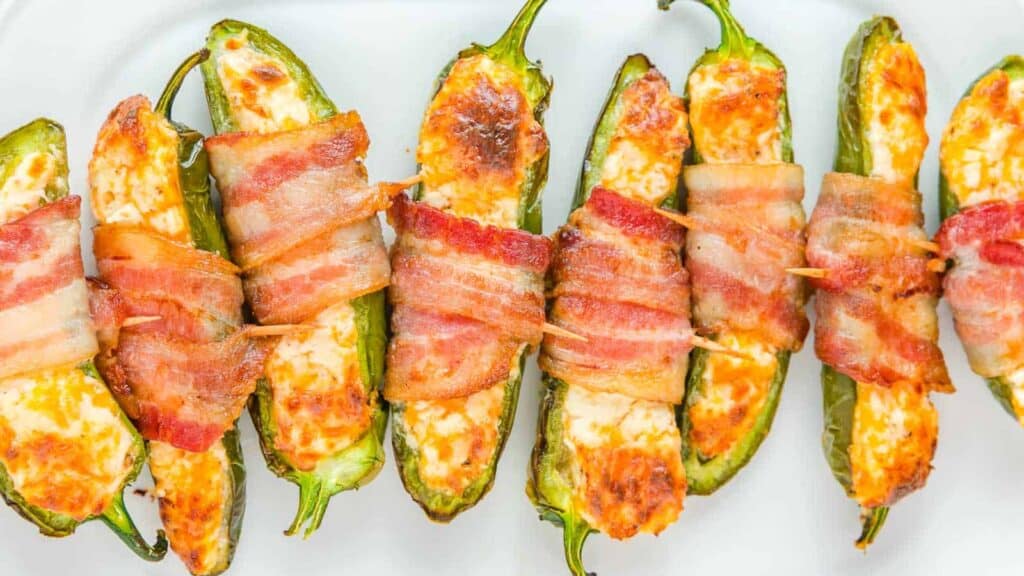 Bacon wrapped jalapenos on a plate.