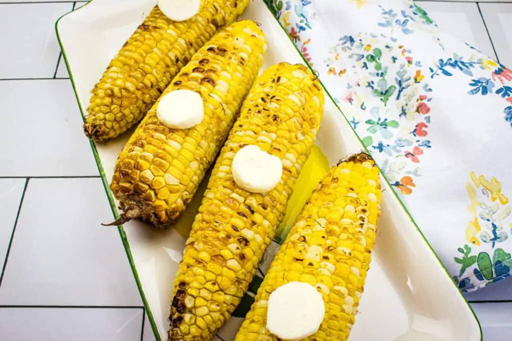 Air Fryer Corn on the Cob on a white platter.