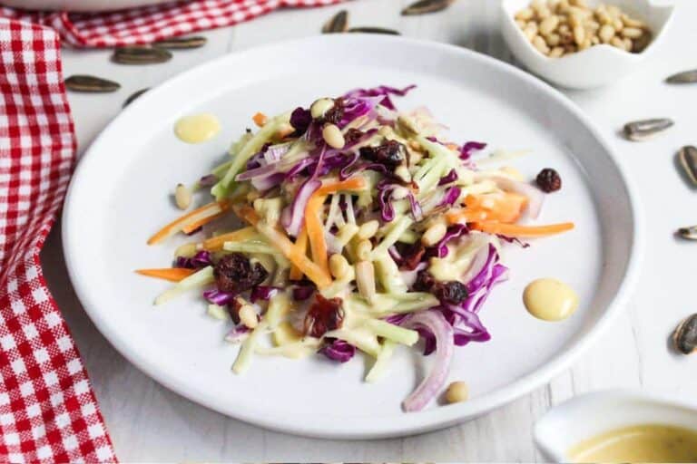 A plate of broccoli slaw with a dressing on it.