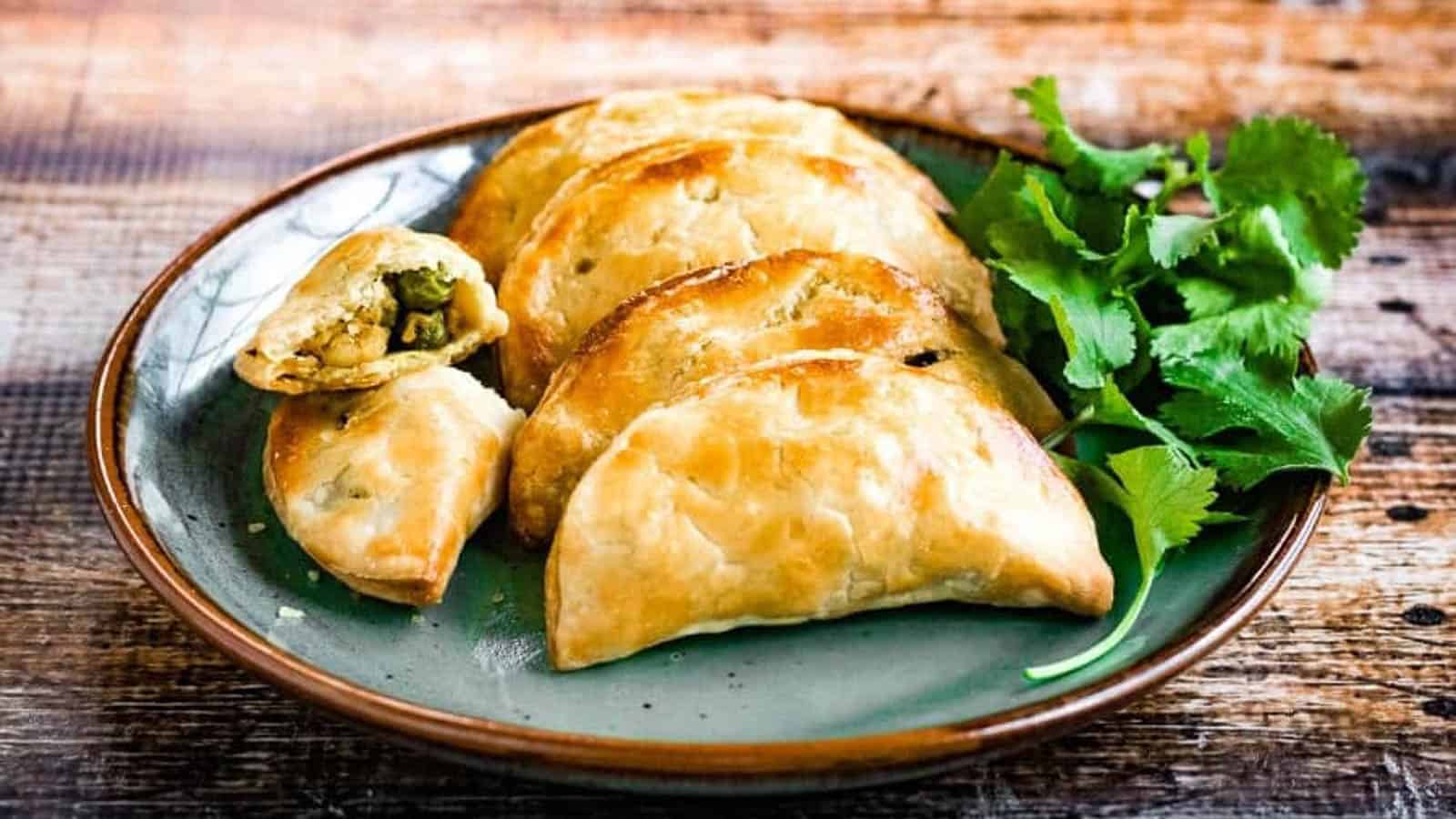 Thai curry puffs filled with ground chicken, potatoes, peas, onions, garlic and spices.