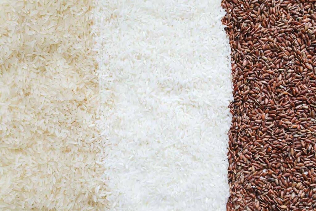 White, brown, and brown rice on a white background.