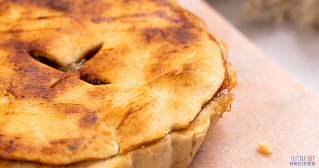 Mini apple pie on cutting board.