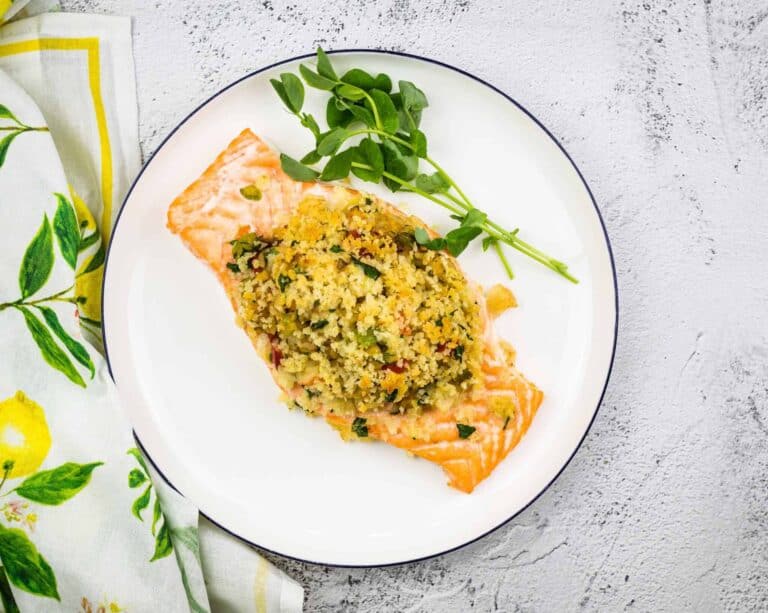 Seafood Stuffed Salmon on a circular white plate.