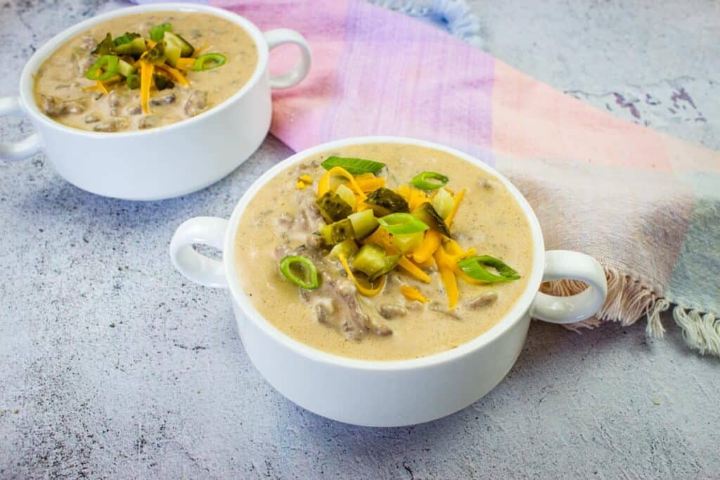 Two bowls of soup on a table.