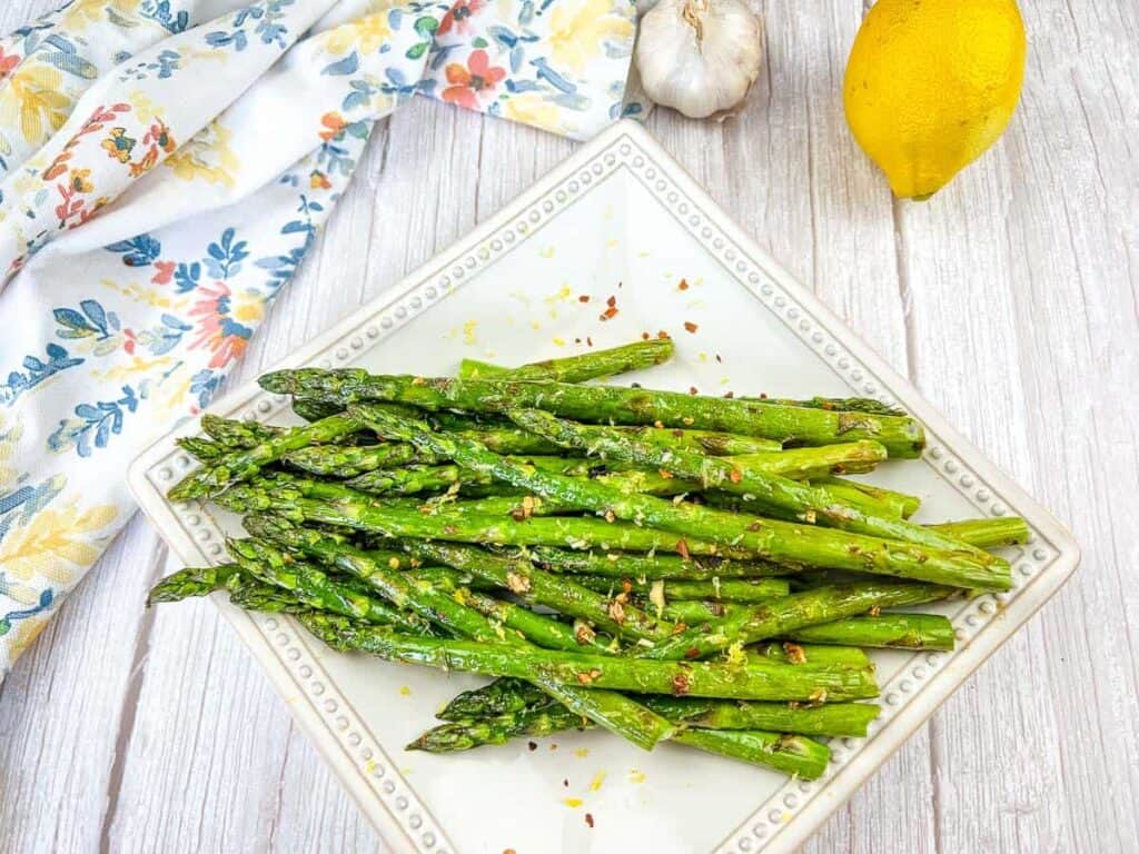 Grilled Asparagus on a white square plate.
