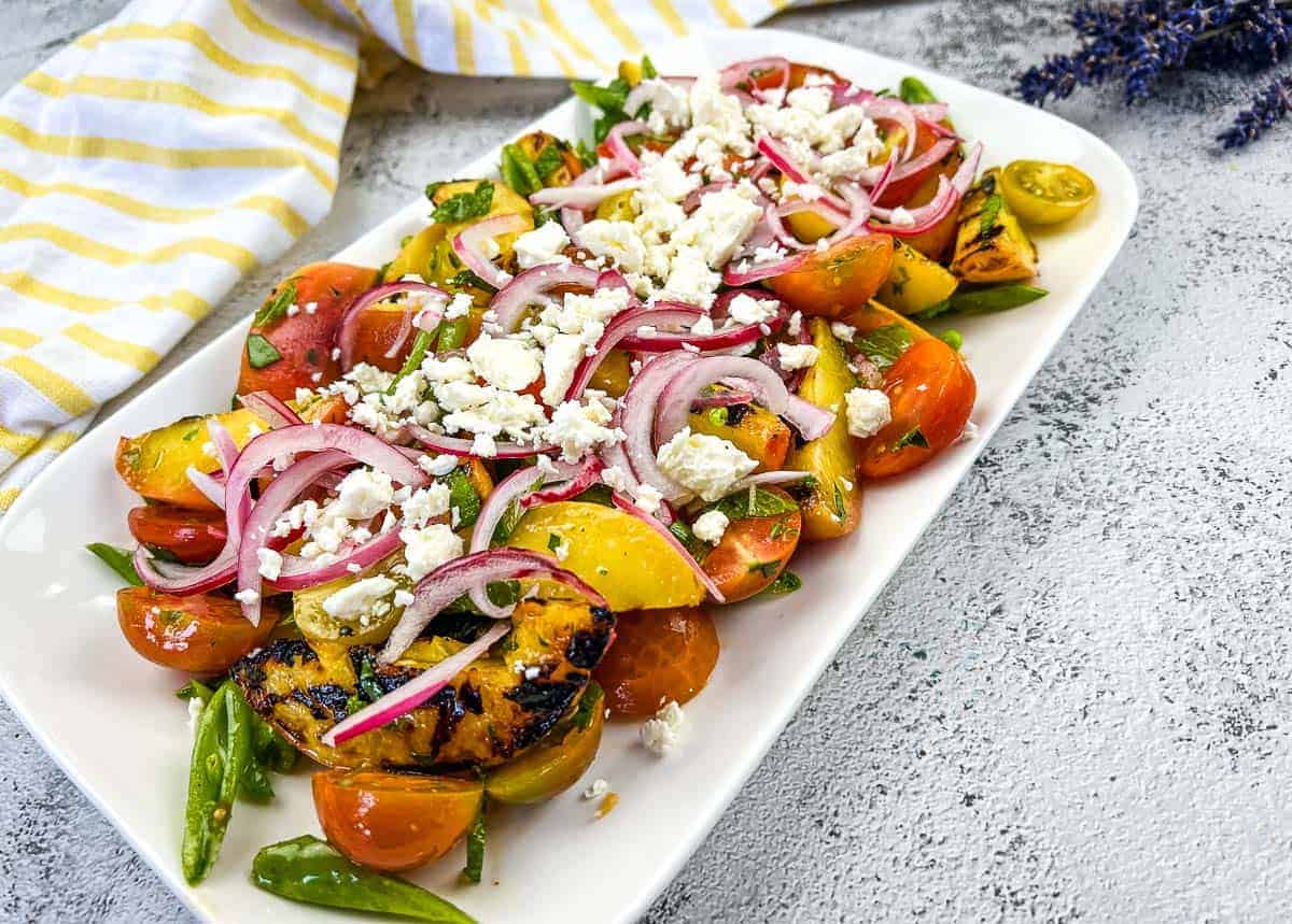 A plate with Grilled Peach Salad with Tomatoes.