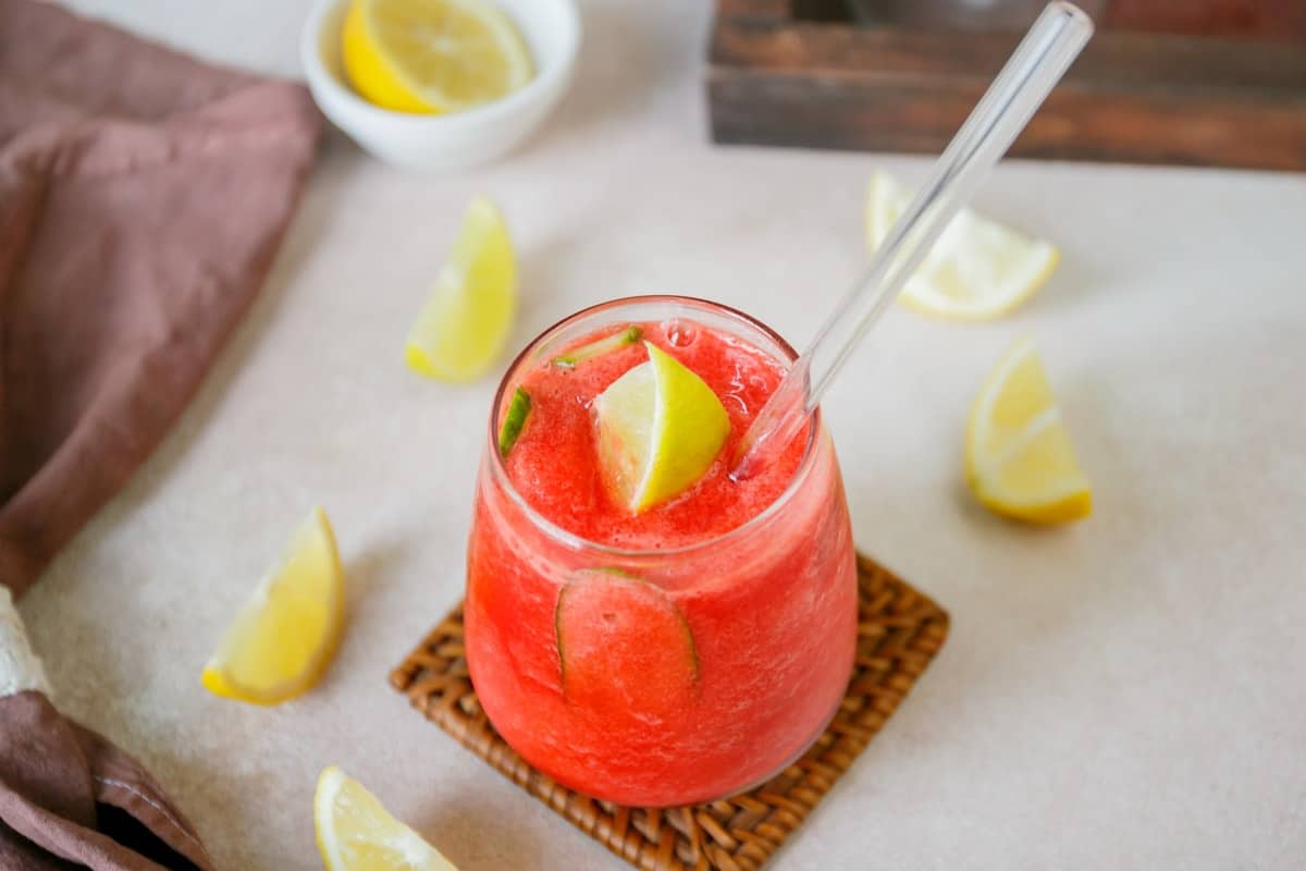 Slushy Nigerian chapman drink in a glass cup with a straw.