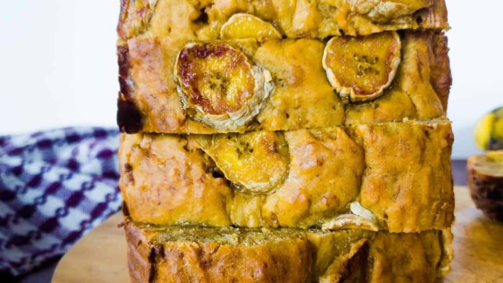 A stack of banana bread on a cutting board.