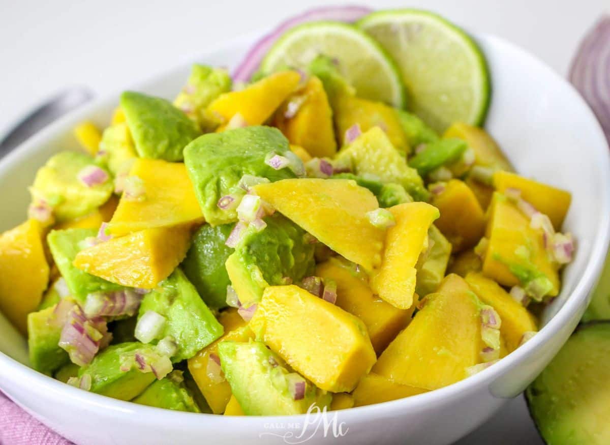 Mango and avocado salad in a white bowl.