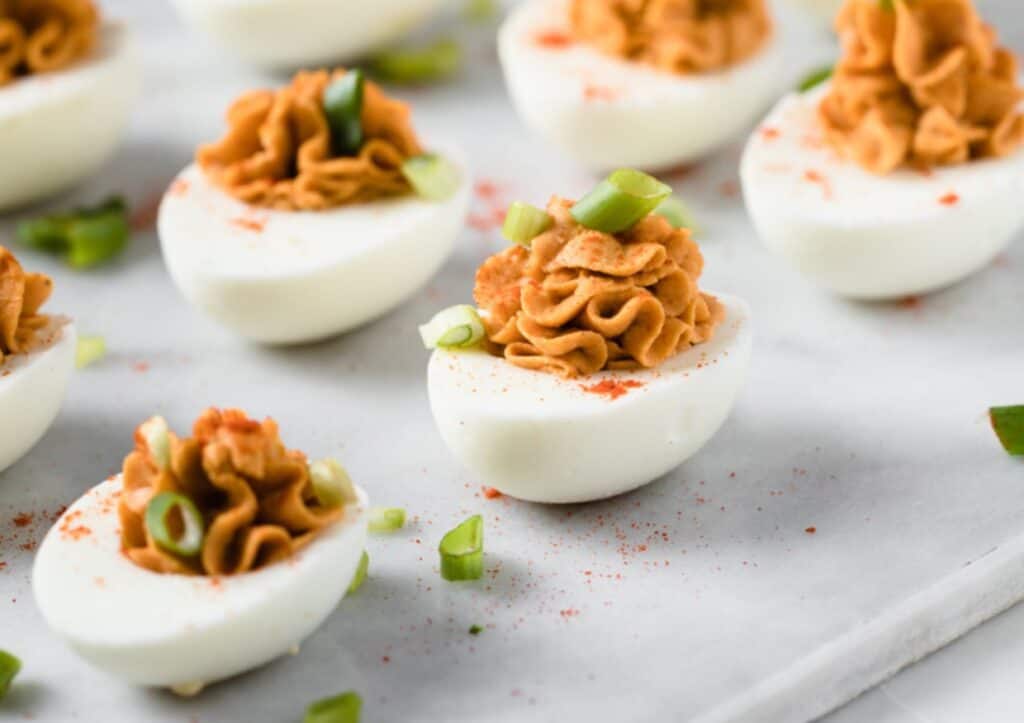 Buffalo deviled eggs and green onions.