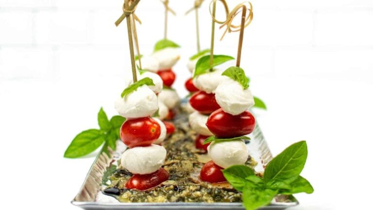Caprese skewers on a silver tray.