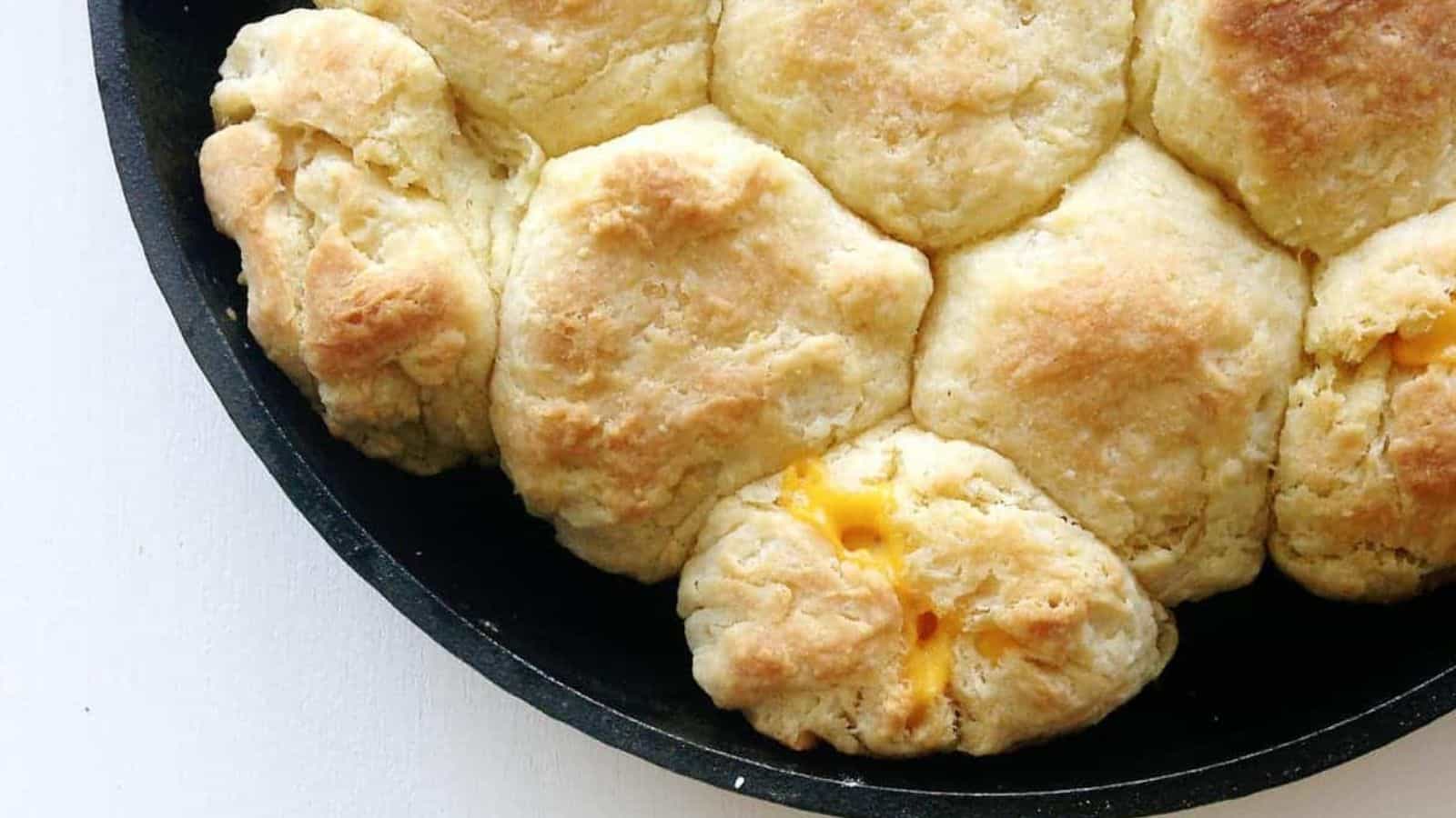 Cheesy biscuits in a skillet on a table.
