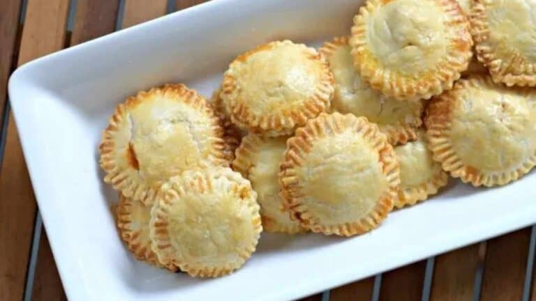 A plate of pies on a wooden table.