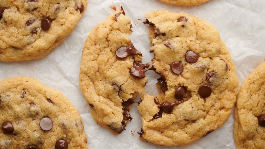 Chocolate chip cookies with a bite taken out of them.