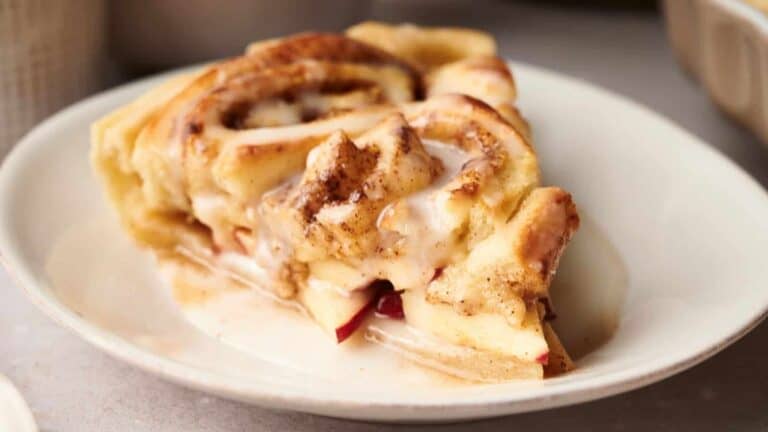 A slice of apple cinnamon roll on a plate.