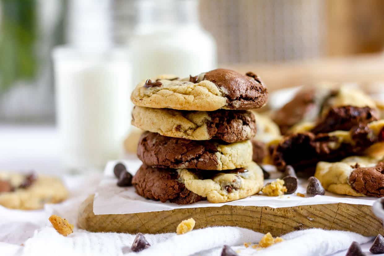 A stack of chocolate chip cookies on a cutting board, perfect for winter desserts.