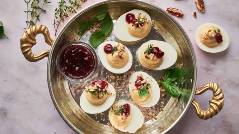 Deviled eggs with cranberry sauce.