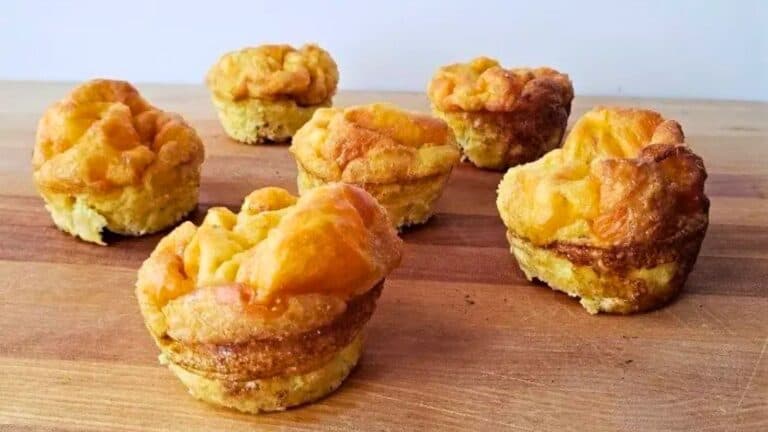 Image shows five Egg Muffin Cups sitting on a wooden board.